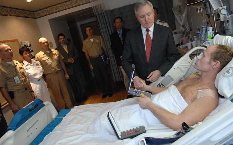 Secretary of the Navy Ray Mabus awards the Bronze Star with Valor medal and a Purple Heart medal to Navy SEAL Lt. Dan Cnossen at the National Medical Center in Bethesda, Md. on Oct. 1, 2009. Cnossen was wounded by an improvised explosive device in Afghanistan. 