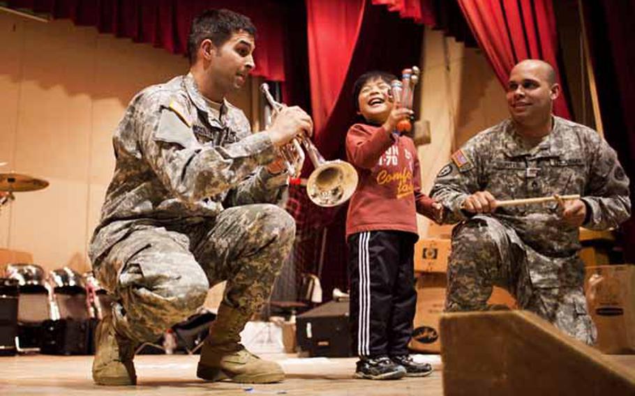 A boy at the Rokugo Middle School shelter in Sendai City dances on stage with the Camp Zama Army Band that played a concert for the residents.