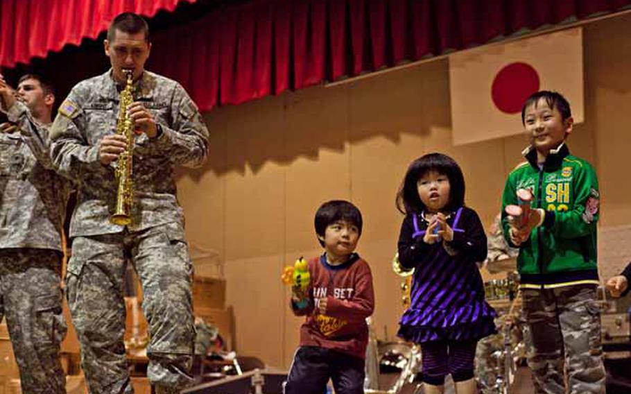 Children at the Rokugo Middle School shelter in Sendai City dance on stage with the Camp Zama Army Band that played a concert for the residents.