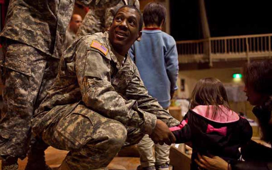 Spc. Travis Poole, 22, asks for a gift for a girl at the Rokugo Middle School shelter in Sendai City, Japan. Poole and 14 other members of the Camp Zama Army Band played a concert for the residents of the shelter and brought gifts donated by the Boy Scout and Girl Scout associations of Camp Zama for the children.