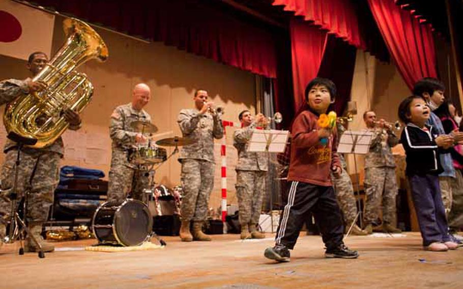 Children at the Rokugo Middle School shelter in Sendai City dance on stage with the Camp Zama Army Band that played a concert for the residents.