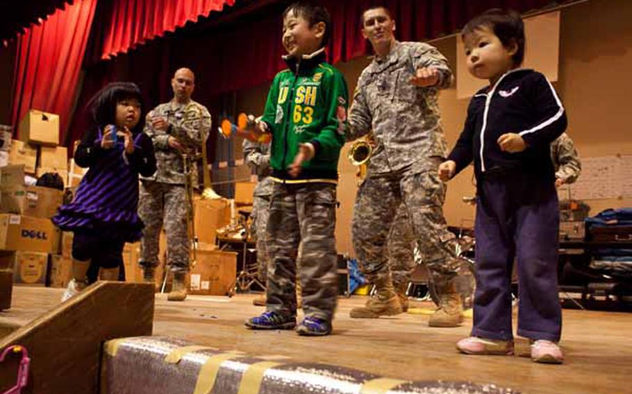 Children at the Rokugo Middle School shelter in Sendai City dance on stage with the Camp Zama Army Band that played a concert for the residents.