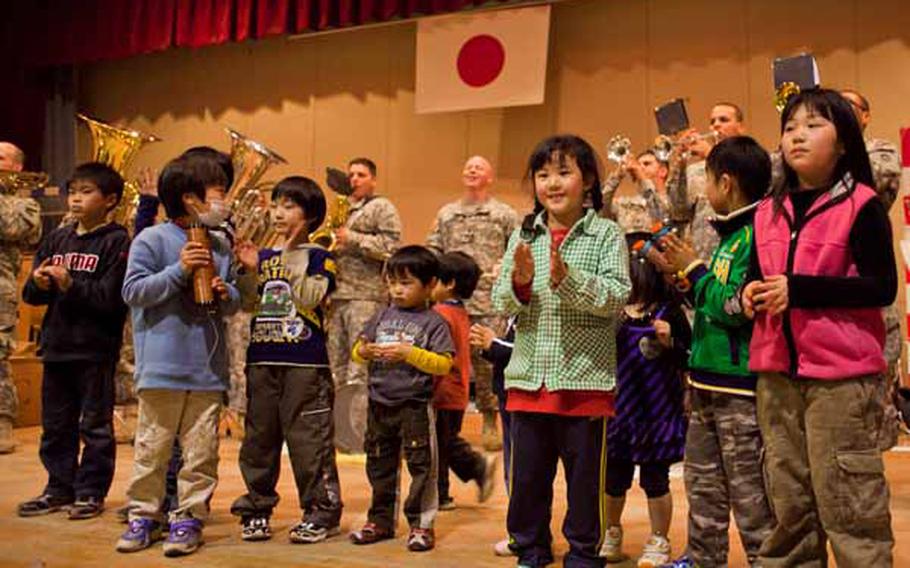 Children at the Rokugo Middle School shelter in Sendai City dance on stage with the Camp Zama Army Band that played a concert for the residents.