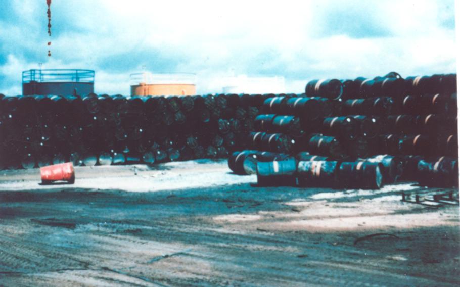 Large stacks of 55-gallon drums filled with Agent Orange.