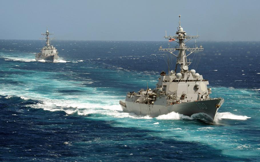 The Arleigh Burke-class guided-missile destroyers USS Kidd (DDG 100) and USS Pinckney (DDG 91)are underway in the Pacific Ocean.