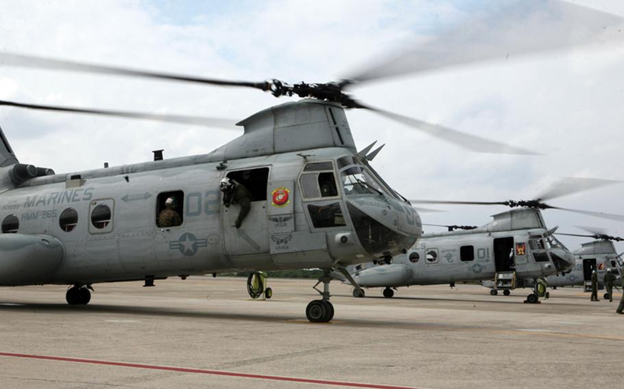 CH-46E Sea Knight helicopters with Marine Medium Helicopter Squadron 265, Marine Aircraft Group 36, 1st Marine Aircraft Wing, III Marine Expeditionary Force, prepare to depart Marine Corps Air Station Futenma on March 12, 2011, to provide assistance in the wake of the earthquakes and tsunami that struck Japan.