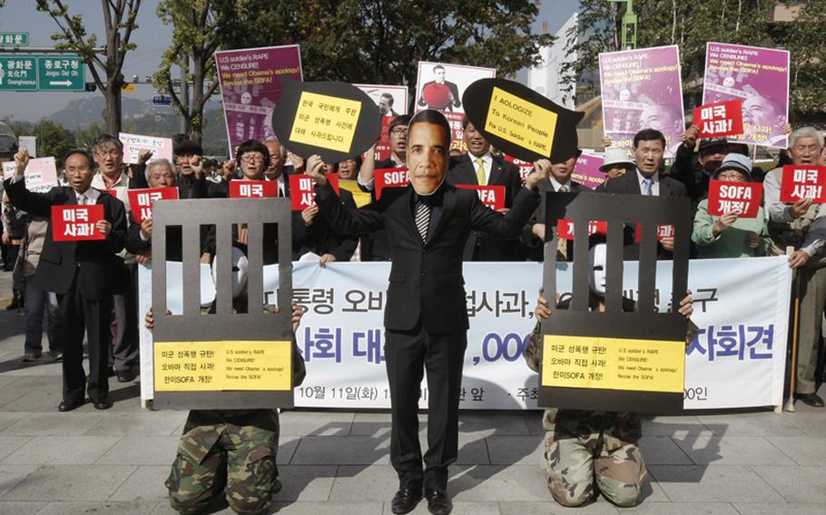 A South Korean protester wearing a mask of U.S. President Barack Obama participates in a march relating to the SOFA between South Korea and the United States. The protest was held near the U.S. Embassy in Seoul on Oct. 11, 2011. The protest was in response to the Sept. 24, 2011, rape of a 17-year-old woman by U.S. Army Pvt. Kevin Flippin.