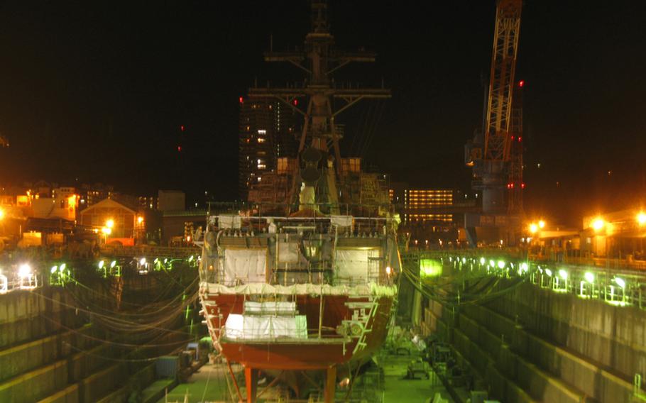 The destroyer USS McCampbell sits in Drydock #5 at Yokosuka Naval Base on Jan. 9, 2012, hours after a Japanese shipyard worker died while working on the ship's overhaul. U.S. Navy and Japanese officials are investigating the death, which preliminary reports indicated was an accident involving an anchor.