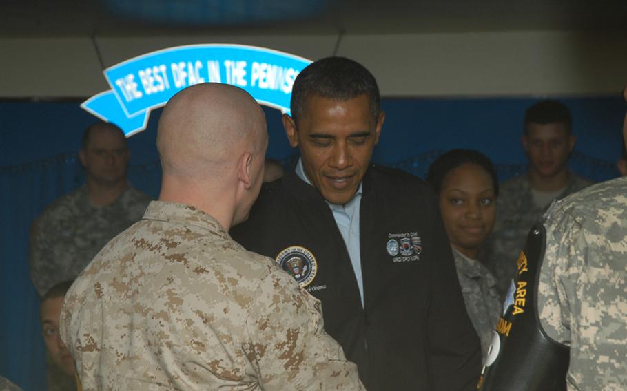 President Barack Obama shakes hands March 25, 2012, with U.S. troops stationed at the Joint Security Area of Korea's Demilitarized Zone. During his brief remarks to servicemembers there, he made of point of giving them the latest scores from the NCAA Basketball Championship tournament.      