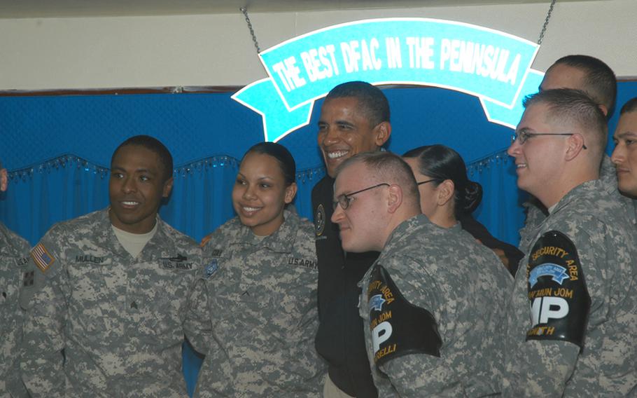 President Barack Obama poses with U.S. troops stationed at the Joint Security Area of Korea's Demilitarized Zone during a visit there March 25, 2012. Obama is in South Korea to attend this week's Nuclear Security Summit.   