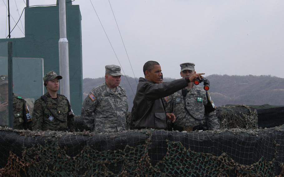 President Barack Obama points in the direction of North Korea on March 25, 2012, during a visit to the Demilitarized Zone. Accompanying Obama at Observation Point Oulettee were U.S. Forces Korea commander Gen. James Thurman, left, and Lt. Col. Ed Taylor, commander of the United Nations Command Security Battalion - Joint Security Area, right. 