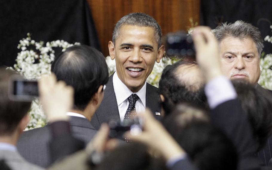 U.S. President Barack Obama greets the audience after his speech at Hankuk University in Seoul, South Korea on March 26, 2012.