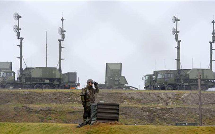 A Japanese soldier stands watch at Japan Air Self-Defense Force's Chinen base in Nanjo, Okinawa Prefecture, southern Japan, Thursday, April 12, 2012. Japan is on alert for North Korean rocket which is expected to launch sometime between April 12-16.