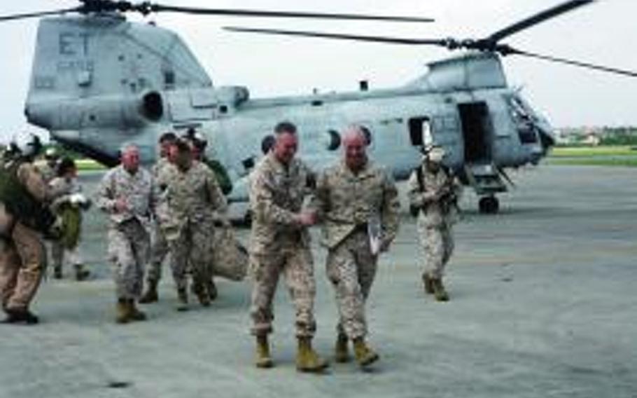 Marine Col. James G. Flynn, right, welcomes Gen. Joseph F. Dunford Jr. to Marine Corps Air Station Futenma, Okinawa, on March 22, 2012. 