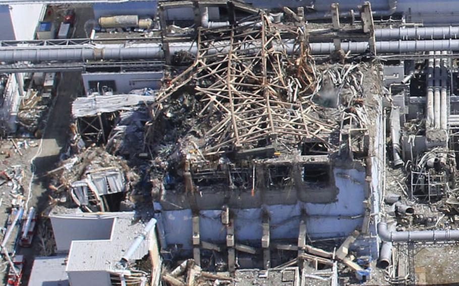 This handout aerial photo dated March 20, 2011, taken by small unmanned drone shows damaged Unit 4, left, and Unit 3 of the crippled Fukushima Daiichi nuclear power plant in Okumamachi, Fukushima prefecture, northern Japan. 