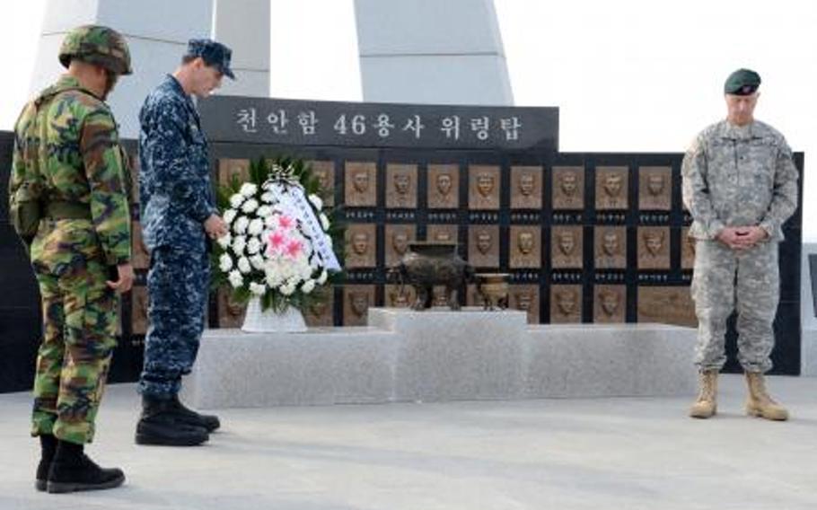 From left, Lt. Col. Cha Jae-Gwan of the Republic of Korea marine corps, U.S. Navy Rear Adm. Bill McQuilkin and Brig. Gen. Neil Tolley, a special operations commander, reflect after laying a wreath at a memorial in October 2011. The Cheonan 46 Warriors Memorial Tower honors South Korean sailors who died in March 2010 when a torpedo, presumably fired by North Korea, sank their ship. South Korea is building a small naval station on the island near where the attack occurred.