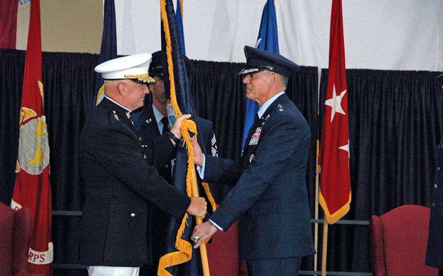 U.S. Pacific Command deputy commander Lt. Gen. Thomas L. Conant, left, passes the U.S. Forces Japan colors to new USFJ and 5th Air Force commander Lt. Gen. Salvatore A. Angelella during a change-of-command ceremony July 20, 2012, at Yokota Air Base, Japan.