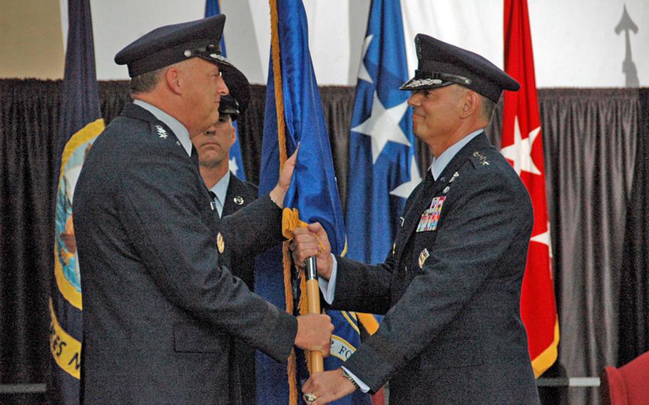 Pacific Air Forces commander Gen. Gary L. North, left, passes the 5th Air Force colors to new U.S. Forces Japan and 5th Air Force commander Lt. Gen. Salvatore A. Angelella on July 20, 2012, at Yokota Air Base, Japan. 
