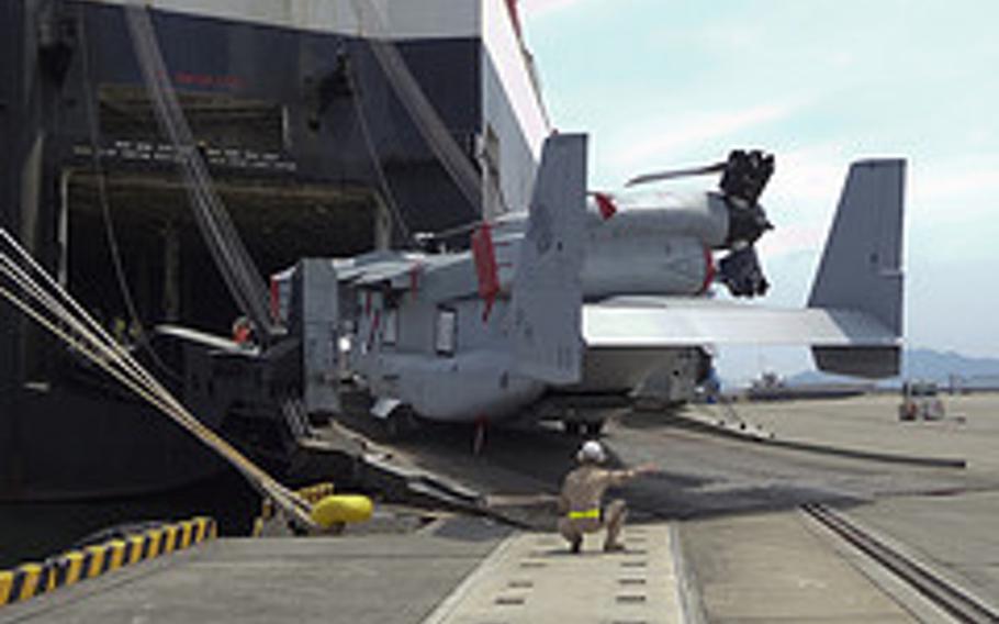 An MV-22 Osprey aircraft with Marine Medium Helicopter Squadron 265 is unloaded from the cargo ship Green Ridge at the Marine Corps Air Station Iwakuni harbor July 23, 2012. This marks the first MV-22 Osprey aircraft deployment to Japan and a milestone in the Marine Corps' process of replacing CH-46E helicopters with the MV-22 Osprey.