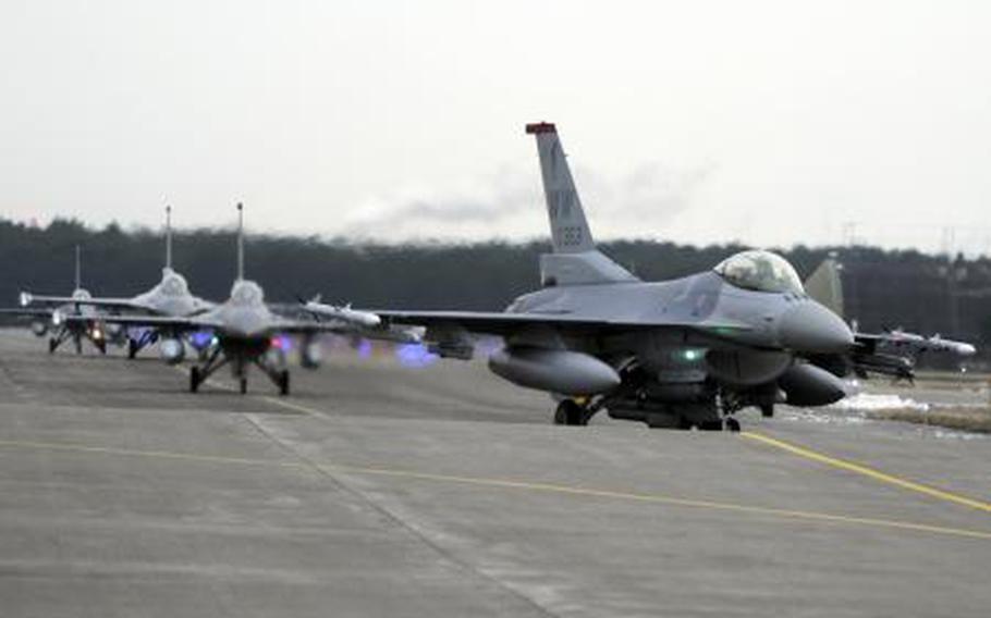 An F-16 with the 35th Fighter Wing taxis on the runway in Misawa, Japan on Jan. 17, 2012.