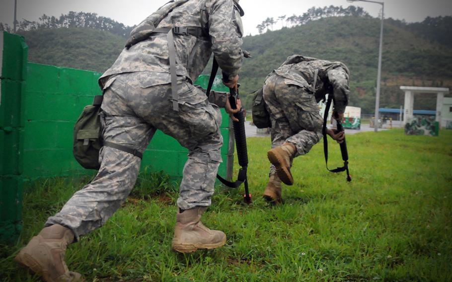 Soldiers of the 498th Combat Sustainment Support Battalion, 501st Sustainment Brigade, bound forward from their firing position during training with South Korean infantry during Ulchi Freedom Guardian 2011. 