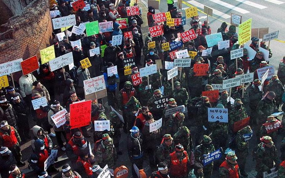 Protesters gather outside U.S. Army Garrison - Yongsan in December 2011 in response to the hiring of a new security firm at bases in South Korea. That security company, British-based G4S, is now being phased out immediately, with a new security firm set to take over security by the end of October.