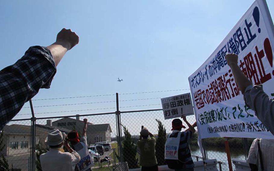 Protesters shout slogans at the MV-22 Osprey test flights begin Friday in Iwakuni, Japan. The Marines are testing the controversial aircraft on mainland Japan before their planned deployment to Okinawa.