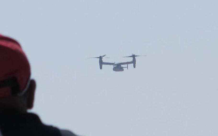 The day did not just belong to members of the media and protesters in Iwakuni on Friday for the commencement of flight operations for the MV-22 Osprey. Here, an old man stands on the sea wall to catch a glimpse of the bird that has become the talk of the town.