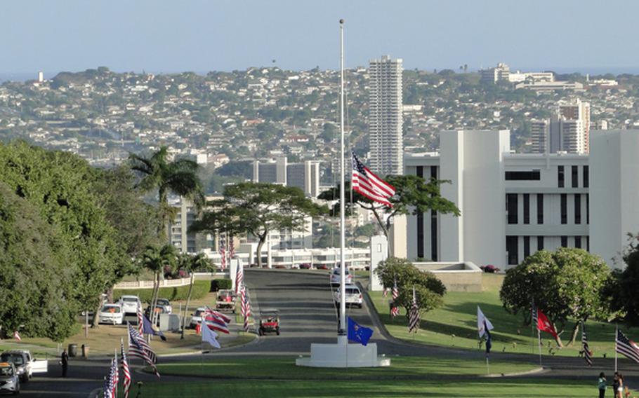 The U.S. flag flies at half staff at the National Memorial Cemetery of the Pacific, which overlooks Honolulu, on Veterans Day, Nov. 11, 2012. 
