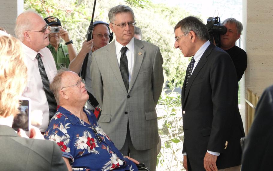 Defense Secretary Leon Panetta, right, speaks with former Sen. Max Cleland, a Vietnam veteran, at a Veterans Day ceremony Nov. 11, 2012, at the National Memorial Cemetery of the Pacific in Hawaii.