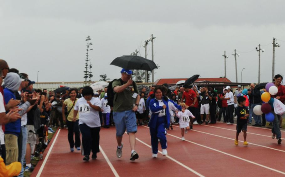 Special-needs athletes compete in 30-meter Dash Saturday during the Kadena Special Olympics games held at Kadena Air Base. 
About 900 athletes from both Okinawa and U.S. military communities participate in the annual inter-community sports event. Also joining in the event are nearly 3,000 U.S. servicemembers, civilians, their families and Japanese volunteers, including cheer girls and band members from Kadena High School. 