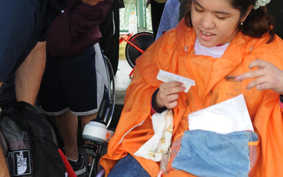 For Nanami Tamayose, the Kadena Special Olympics is a special event that she looks forward to every year. She conveys her joy to Capt. Richard Weathers, commanding officer of the Fleet Activities Okinawa, by reading a note she prepared in English. About 900 special-needs athletes from both Okinawa and U.S. military communities compete in the annual sports event. Nearly 3,000 American and Japanese volunteers gather the air base to cheer the athletes and support the goodwill event.