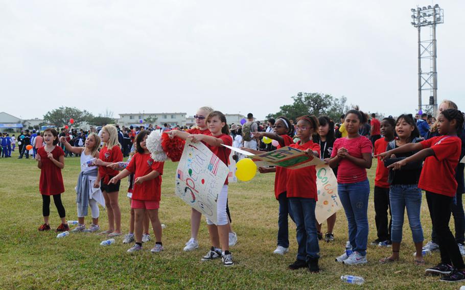 Students from Amelia Earhart Intermediate School at Kadena Air Base join in the 13th Kadena Special Olympic Saturday to cheer their classmates who participate in the annual sports event. About 900 special-needs athletes compete in the games while nearly 3,000 volunteers gather the air base to support the event and cheer the athletes.