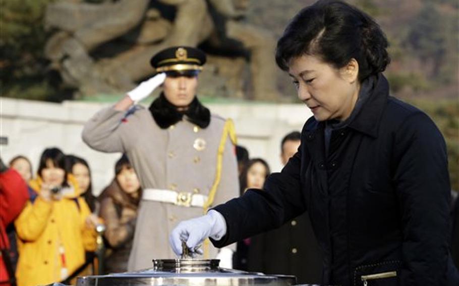 South Korean President-elect Park Geun-hye of the ruling Saenuri Party burns incense during her visit to the National Cemetery in Seoul, South Korea, Thursday, Dec. 20, 2012. Park, daughter of a divisive military strongman from South Korea's authoritarian era, was elected the country's first female president Wednesday, a landmark win that could mean a new drive to start talks with rival North Korea.