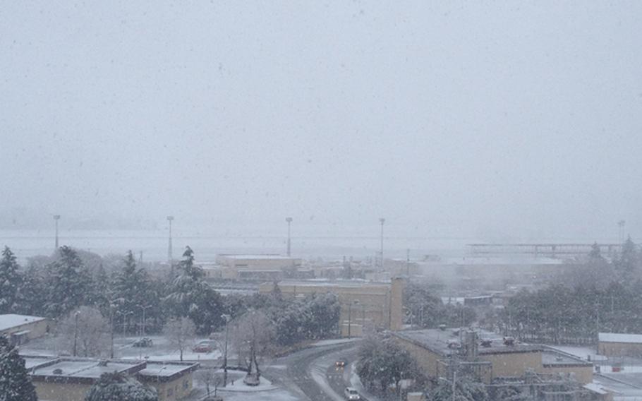 Snowfall obscures the runway in the distance at Yokota Air Base in western Tokyo, Jan. 14, 2013.