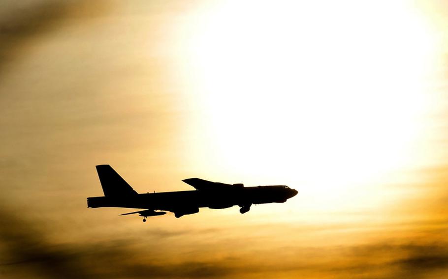 A B-52 Stratofortress flies just under the sun after flying a routine sortie at Minot Air Force Base, N.D. on Nov. 20, 2012. 