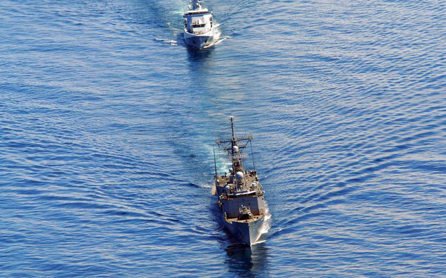 The guided missile frigate USS Reuben James, foreground, and the Royal Brunei Navy offshore patrol vessel Darulehsan sail in formation during Cooperation Afloat Readiness and Training (CARAT) 2012 in November 2012, in the South China Sea.