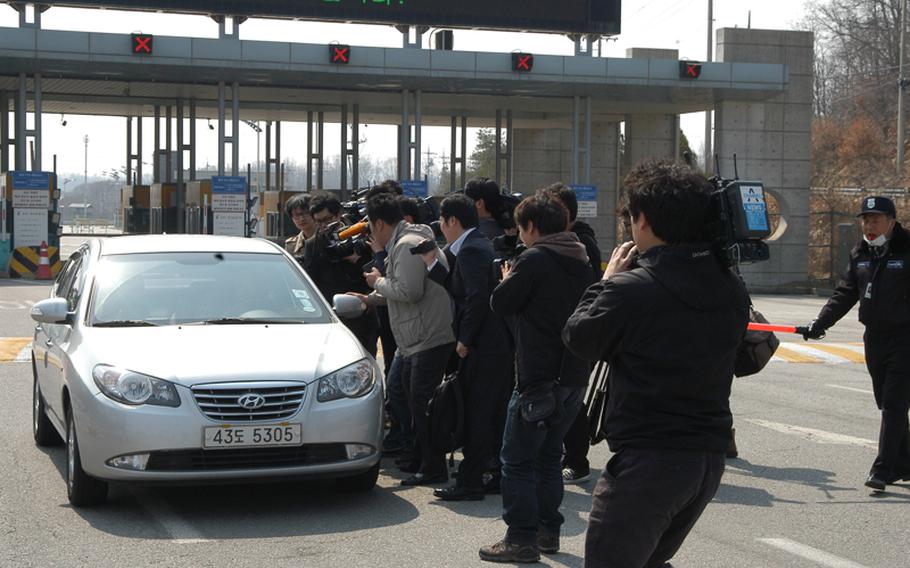 Members of the South Korean media swarm a vehicle April 3, 2013, returning from the Kaesong Industrial Complex in North Korea hoping for an interview with the driver, who subsequently drove hastily through the crowd without comment. North Korea barred South Koreans from commuting to the complex just north of the Demilitarized Zone on April 3, 2013, the latest move aimed at protesting United Nations sanctions and ongoing joint U.S.-South Korea military exercises.
