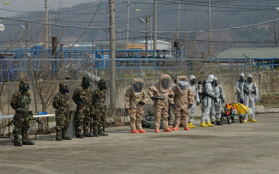 Members of the 23rd Chemical Battalion don protective gear to participate in a demonstration on April 4, 2013, at Camp Stanley in South Korea.