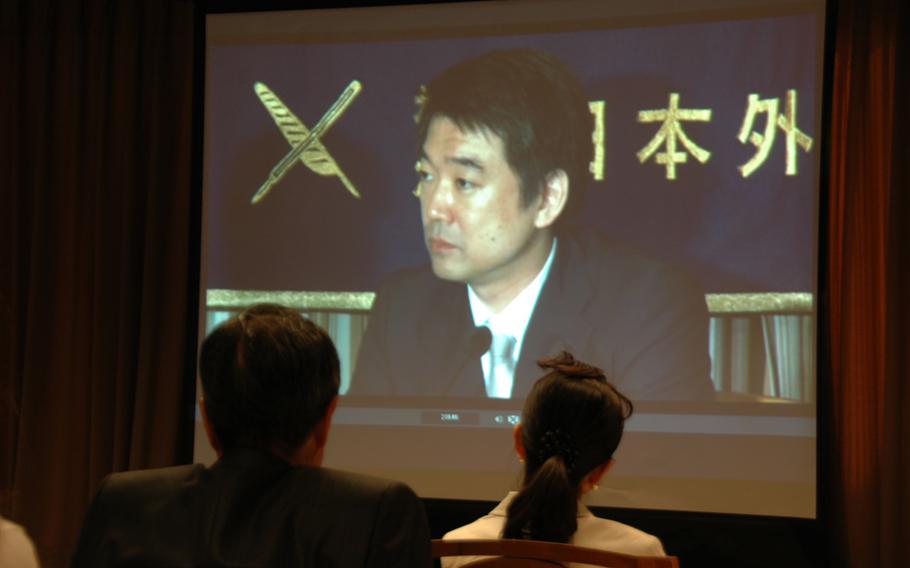 Journalists watch Osaka Mayor Toru Hashimoto the Foreign Correspondents' Club of Tokyo on May 27, 2013. So many reporters showed up to hear the politician's controversial views about prostitution and the military that some had to watch his speech on a screen.