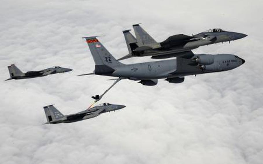 Three F-15 jets from Kadena Air Base refuel above Okinawa, Japan, from a KC-135 Stratotanker April 5, 2013.