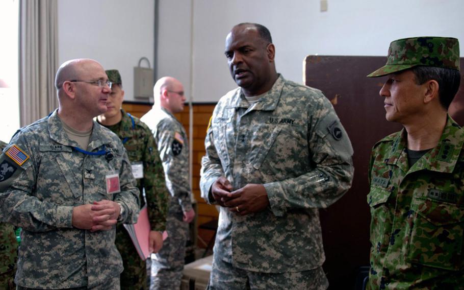 Maj. Gen. Michael T. Harrison, center, then-commander of U.S. Army Japan & I Corps (Forward), talks with Col. Frank Clark and Lt. Gen. Kiyofuni Iwata, commander of Northern Army, Japan Ground Self Defense Force, while touring exercise Sapporo Epicenter, a humanitarian assistance and disaster relief exercise held at Camp Sapporo, Hokkaido, Japan, in late January 2013.