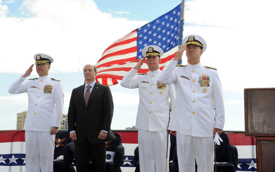 Vice Adm. Robert Thomas Jr., right, salutes after taking command July 31, 2013, of the U.S. 7th Fleet alongside departing U.S. 7th Fleet commander Vice Adm. Scott H. Swift, during a ceremony aboard the USS Blue Ridge in Cairns, Australia. With Thomas and Swift are Capt. John Shimotsu, fleet chaplain, left, and U.S. Ambassador to Australia Jeffrey Bleich. 