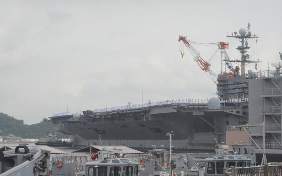 The aircraft carrier USS George Washington arrives at Yokosuka Naval Base's Pier 12 while its sailors man the rails on Friday. About 5,000 sailors disembarked the ship, which returned to Yokosuka for a break in its ongoing Western Pacific patrol.
