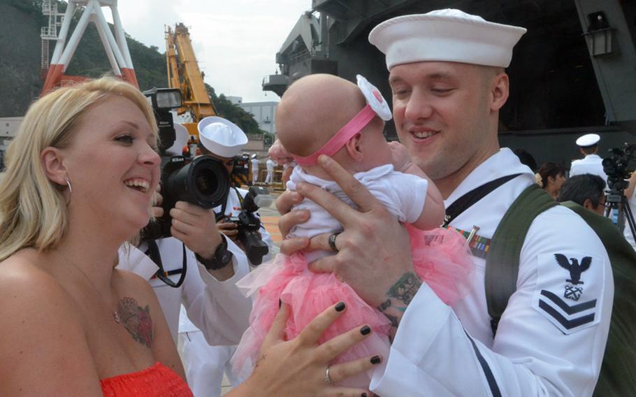 Petty Officer 2nd Class Joshua Dingman greets his wife and meets his 7-week-old daughter, Evelynn, for the first time at Yokosuka Naval Base on Friday. About 5,000 sailors disembarked from the aircraft carrier USS George Washington, which returned to Yokosuka for a break in its ongoing Western Pacific patrol.
Erik Slavin/Stars and Stripes