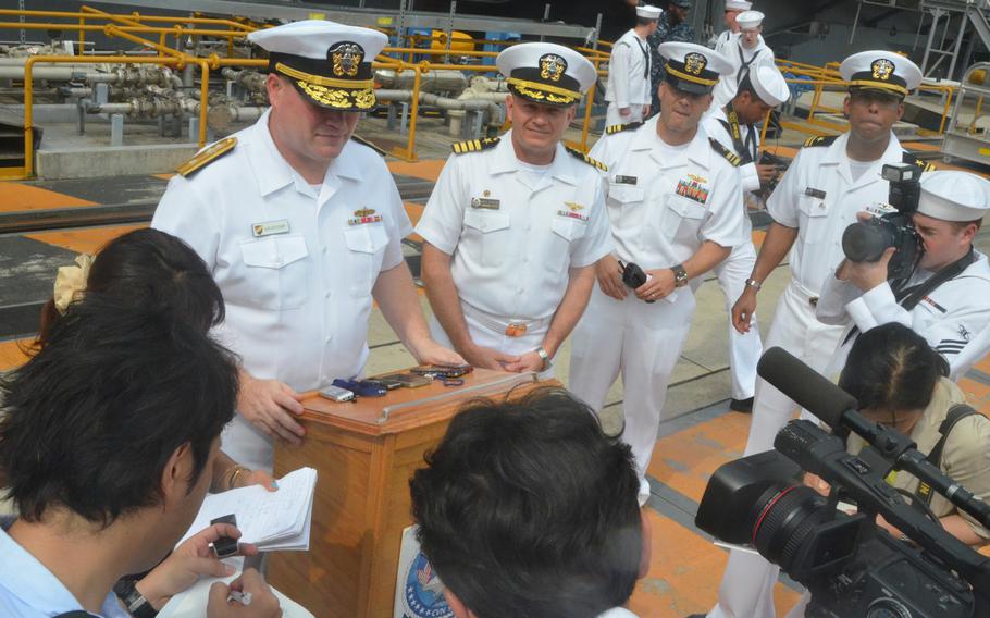 Rear Adm. Mark Montgomery, left, and Capt. Greg Fenton, second from left, take questions from Japanese reporters at Yokosuka Naval Base on Friday. About 5,000 sailors disembarked from the aircraft carrier USS George Washington, which returned to Yokosuka for a break in its ongoing Western Pacific patrol.
