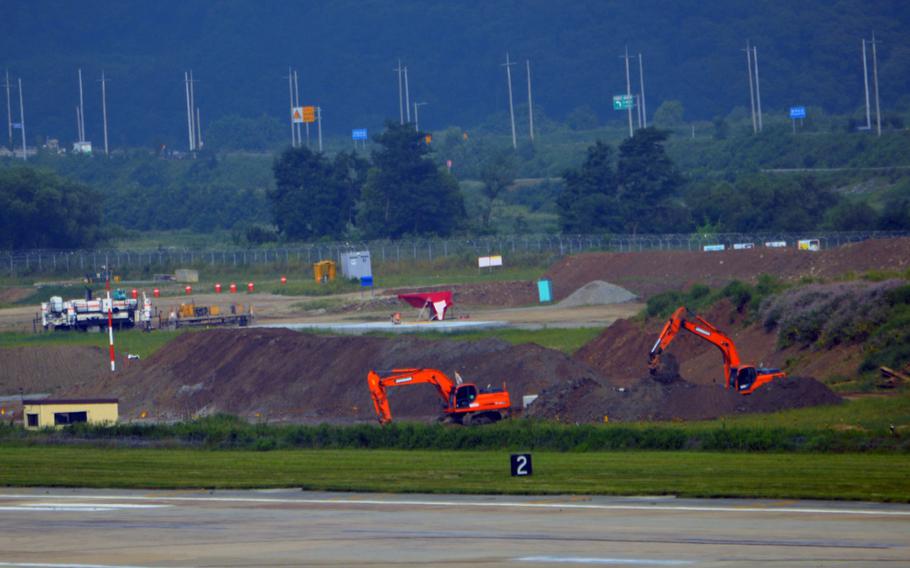 Construction crews dig and remove soil at a construction site at Osan Air Base, South Korea, Aug. 30, 2013. The construction will allow for a second parallel runway. 