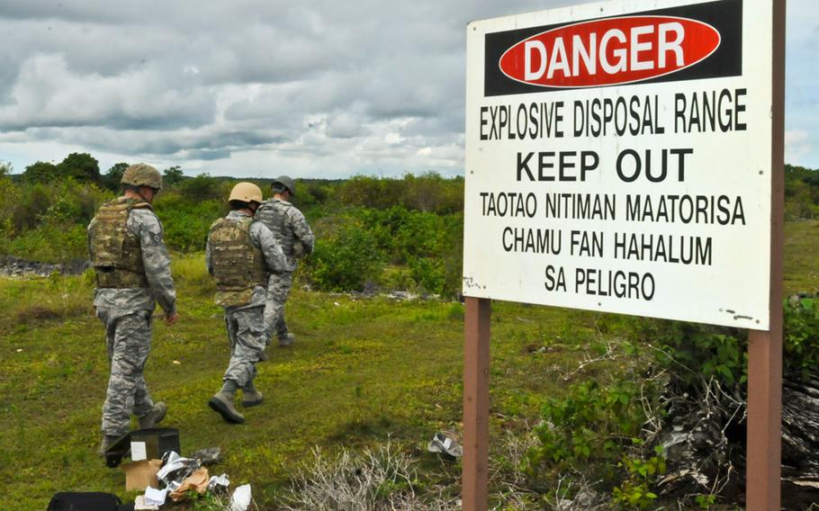 Airmen with engineering and ordnance explosion units train with ground burst simulators on a range at Andersen Air Force Base, Guam, Aug. 26, 2013.