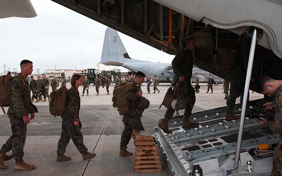 Marines board a KC-130J Hercules aircraft Sunday, Nov. 10, 2013, at Marine Corps Air Station Futenma, Okinawa, Japan, moments before departing for a humanitarian assistance and disaster relief mission to the Philippines. 