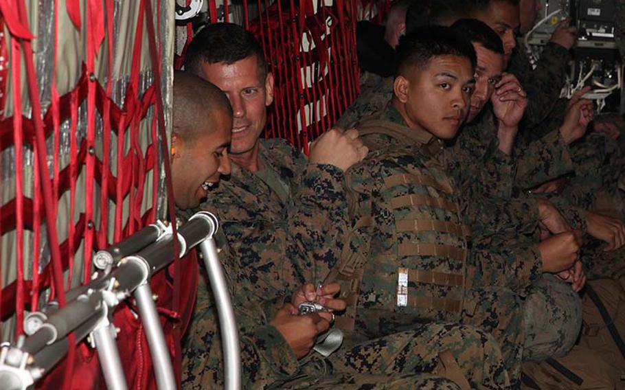 Marines prepare to deploy aboard a KC-130J Hercules aircraft Monday, Nov. 11, 2013, at Marine Corps Air Station Futenma, Okinawa, Japan. About 300 Marines and sailors assigned to the forward command element/humanitarian assistance survey team are deploying to the Philippines from Okinawa after Typhoon Haiyan. 